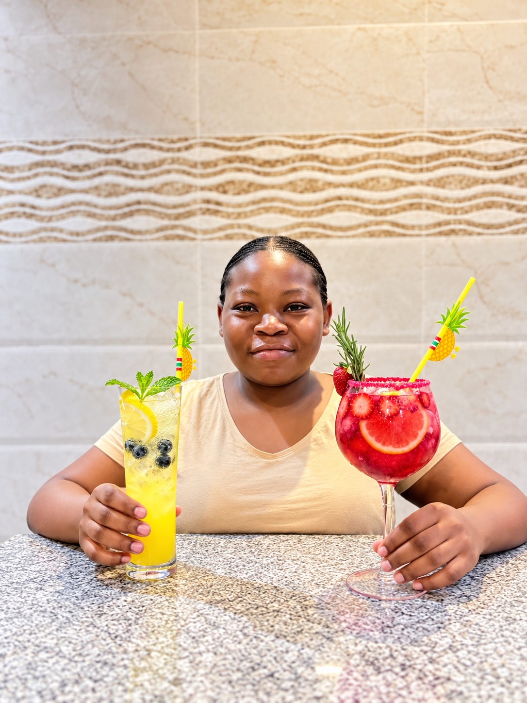 Nsuku, founder of Golden Drinks, holding two colourful cocktails